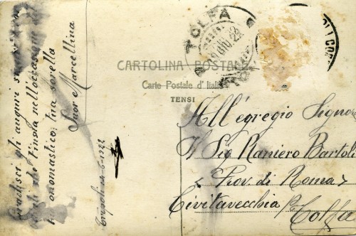 Retro di cartolina con scritta a penna “Gradisci gli auguri sinceri e ?? che ti invia nell'occasione del tuo onomastico; tua sorella/ suor Marcellina/Tripoli 14-6-1922